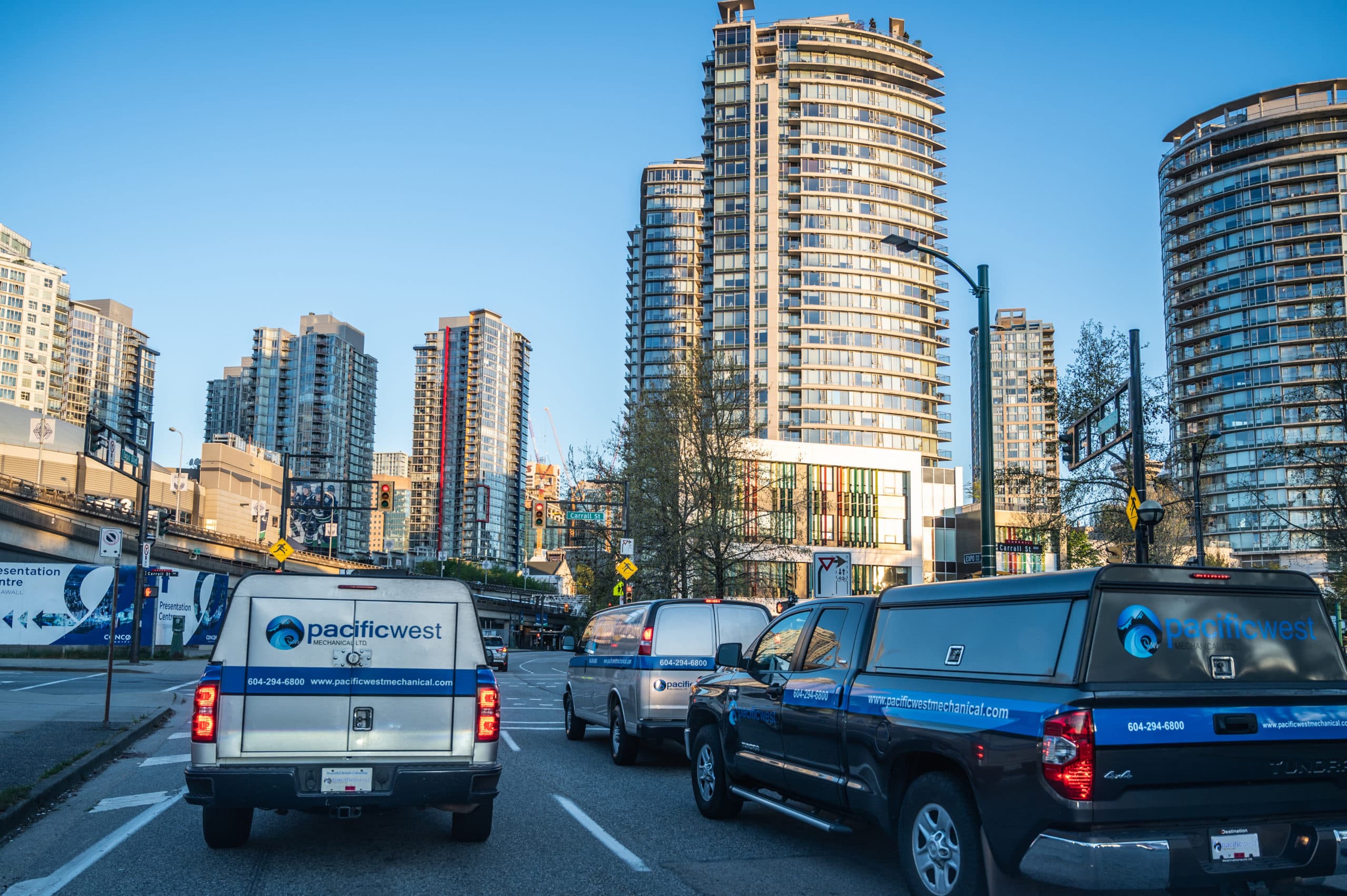 Pacific West Mechanical trucks on a downtown Vancouver street